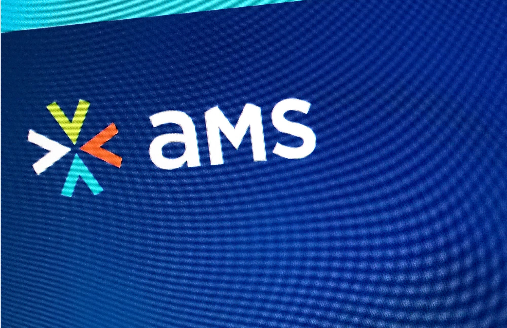 White AMS wordmark and multicolored chevron symbol printed on navy fabric
